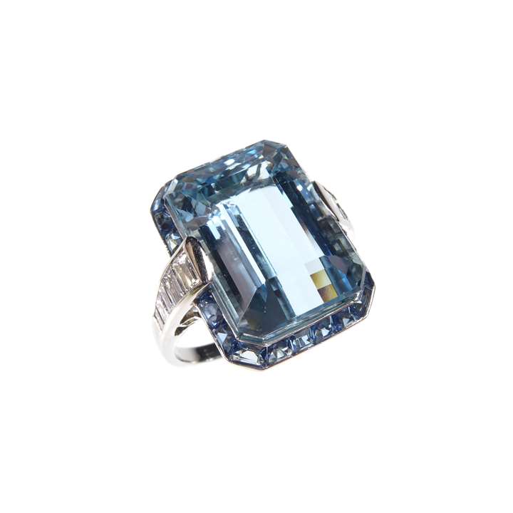 Aquamarine, gem and diamond cluster dress ring, with a principal rectangular trap-cut aquamarine